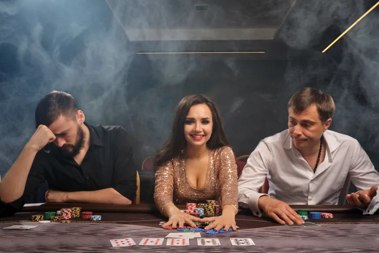 Designed by Freepik. Group of a young rich friends are playing poker in casino.